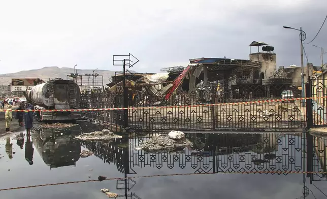 People inspect a damaged petrol station hit in Israeli airstrikes on Sunday, in Sanaa, Yemen, Monday, Aug. 25, 2025. (AP Photo)