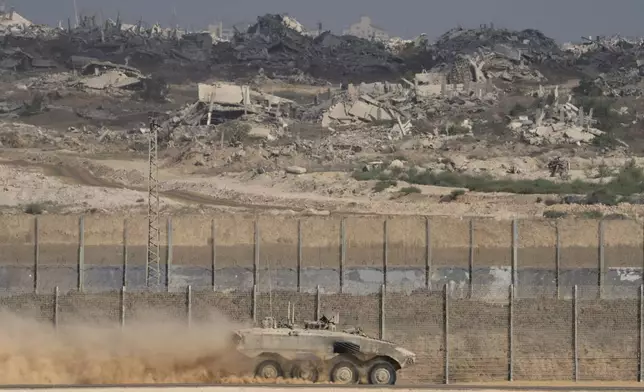 An Israeli armored personnel carrier (APC) moves along the Israeli-Gaza border, as seen from southern Israel, Tuesday, Aug. 26, 2025. (AP Photo/Maya Levin)