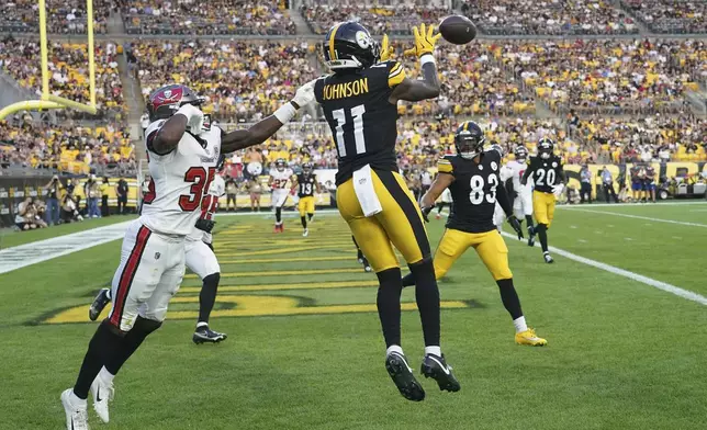 Pittsburgh Steelers wide receiver Brandon Johnson (11) catches a pass from quarterback Mason Rudolph for a touchdown with Tampa Bay Buccaneers cornerback Jacob Parrish defending during the first half of an NFL football preseason game, Saturday, Aug. 16, 2025 in Pittsburgh. (AP Photo/Matt Freed)
