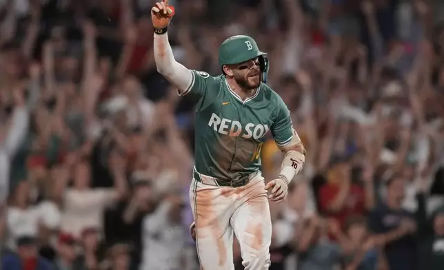 Boston Red Sox's Trevor Story celebrates his game-winning RBI single in the bottom of the ninth inning of a baseball game against the Miami Marlins at Fenway Park, Friday, Aug. 15, 2025, in Boston. (AP Photo/Charles Krupa)