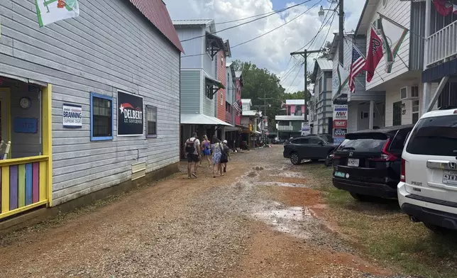 Colorful cabins, covered in flags and political signs, make up the residential section of the Neshoba County Fair in Philadelphia, Miss. on Wednesday, July 30, 2025. (AP Photo/Sophie Bates)