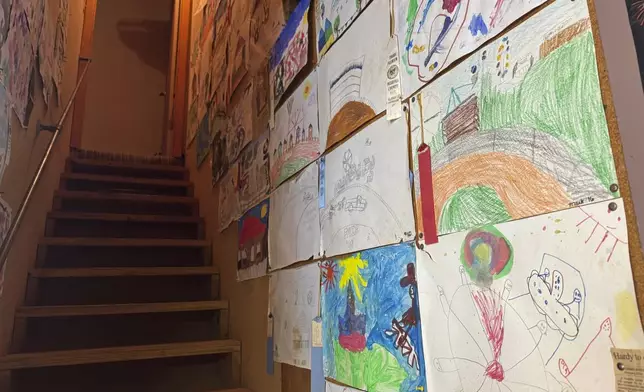 The interior of Hardy family cabin with artworks from multiple generations hanging on the walls is seen at the Neshoba County Fair on Wednesday, July 30, 2025, in Philadelphia, Miss. (AP Photo/Sophie Bates)