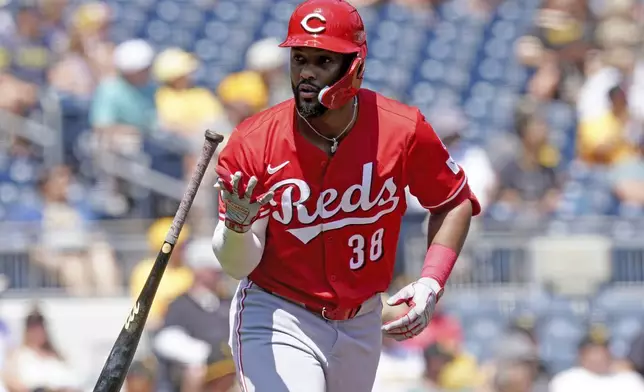 Cincinnati Reds' Miguel Andujar tosses his bat after hitting a three-run home run during the third inning of a baseball game against the Pittsburgh Pirates, Sunday, Aug. 10, 2025, in Pittsburgh. (AP Photo/Matt Freed)