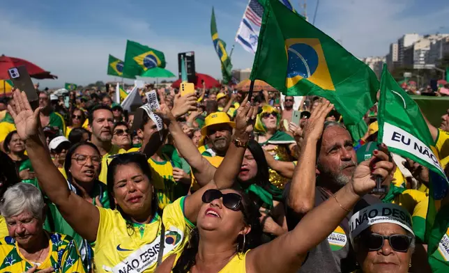 People take part in a demonstration to protest Brazil's former President Jair Bolsonaro's Supreme Court trial where he faces charges for alleged involvement in a 2022 coup attempt, at Copacabana Beach, in Rio de Janeiro, Sunday, Aug. 3, 2025. (AP Photo/Bruna Prado)