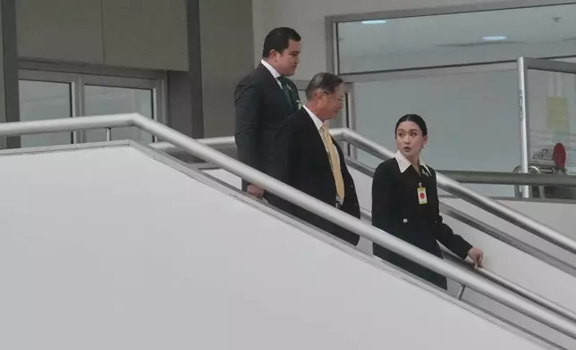 Thailand's suspended Prime Minister Paetongtarn Shinawatra, right, leaves the Constitution Court after giving testimony in Bangkok, Thailand, Thursday, Aug. 21, 2025. (AP Photo/Sakchai Lalit)