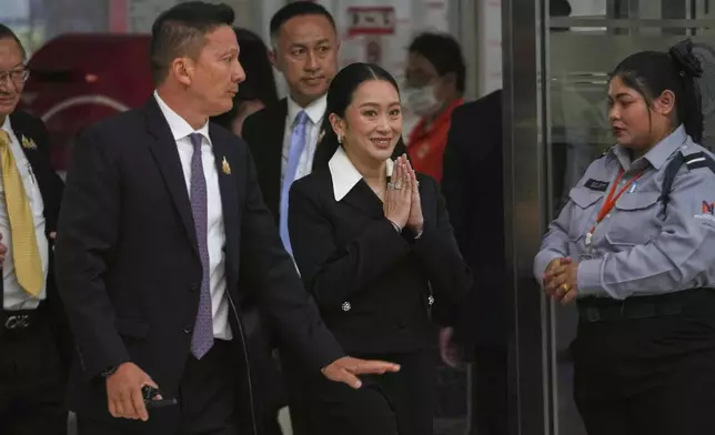 Thailand's suspended Prime Minister Paetongtarn Shinawatra, center, arrives at Constitution Court to give testimony in Bangkok, Thailand, Thursday, Aug. 21, 2025. (AP Photo/Sakchai Lalit)