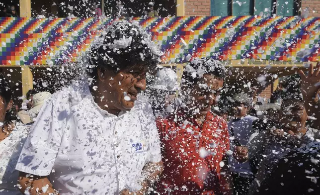Supporters throw confetti on former President Evo Morales after a meeting with a peasants' federation, before he voted in presidential and legislative elections in Villa 14 de Septiembre, in the Chapare region of Bolivia, Sunday, Aug. 17, 2025. (AP Photo/Jorge Saenz)