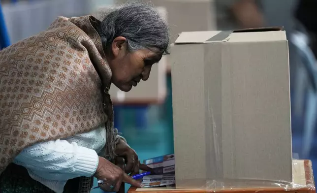 A voter marks her ballot during presidential and legislative elections in La Paz, Bolivia, Sunday, Aug. 17, 2025. (AP Photo/Natacha Pisarenko)