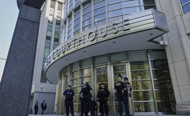 A group of Department of Homeland Security Police stand outside Federal court in the Brooklyn borough of New York, Monday, Aug. 25, 2025. (AP Photo/Richard Drew)