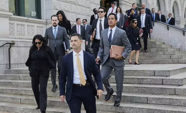 A group of people from the U.S. Attorney's office walk to Federal court in the Brooklyn borough of New York, Monday, Aug. 25, 2025. (AP Photo/Richard Drew)