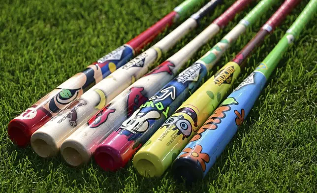Custom bats for Players' Weekend are seen before a game between the Atlanta Braves and Cleveland Guardians, Friday, Aug. 15, 2025, in Cleveland. (AP Photo/David Dermer)