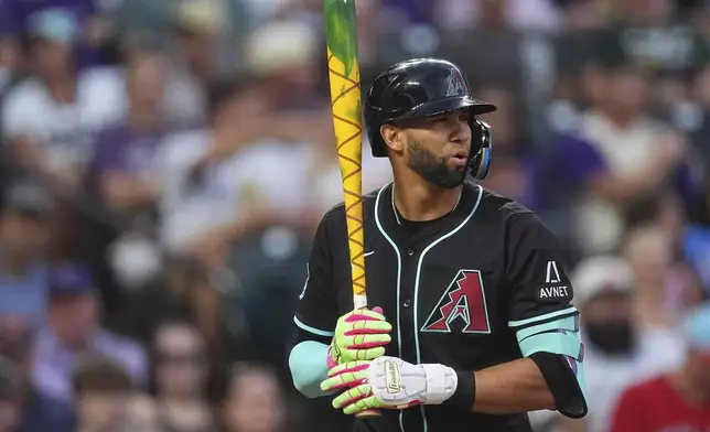 Arizona Diamondbacks' Lourdes Gurriel Jr. steps in the batter's box with his bat decorated for players' weekend in the fourth inning of a baseball game against the Colorado Rockies Friday, Aug. 15, 2025, in Denver. (AP Photo/David Zalubowski)