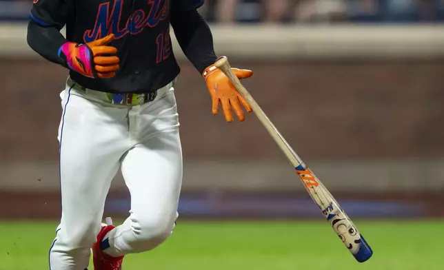 New York Mets' Francisco Lindor (12) throws a bat with Mr. Mets' face printed as part of Players' Weekend during the fourth inning of a baseball game against the Seattle Mariners, Friday, Aug. 15, 2025, in New York. (AP Photo/Yuki Iwamura)