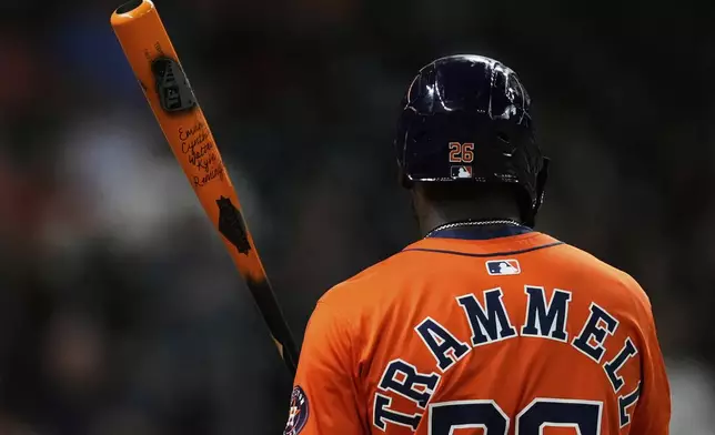 Houston Astros' Taylor Trammell holds his custom bat during the third inning of a baseball game against the Baltimore Orioles in Houston, Friday, Aug. 15, 2025. (AP Photo/Ashley Landis)