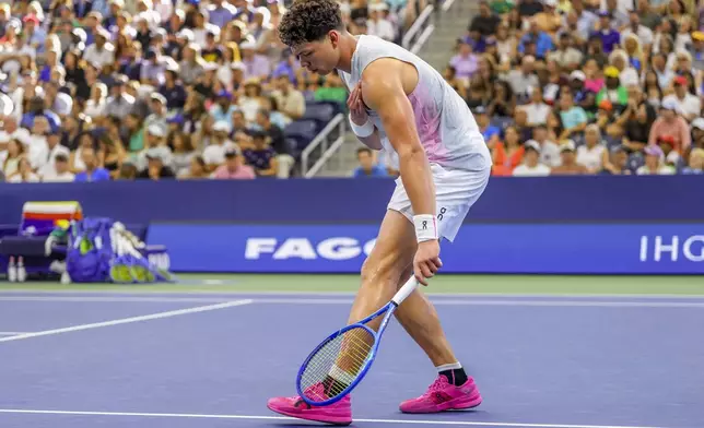Ben Shelton, of the United States, reacts after a rally against Adrian Mannarino, of France, during the third round of the U.S. Open tennis championships, Friday, Aug. 29, 2025, in New York. (AP Photo/Kirsty Wigglesworth)