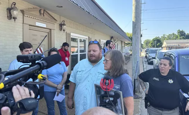 The parents of James M. Wilson, Matthew Wilson, left, and Kim Hamil, speak with reporters after a court hearing for a man charged with killing four people, Thursday, Aug. 7, 2025, in Tiptonville, Tenn. (AP Photo/Adrian Sainz)