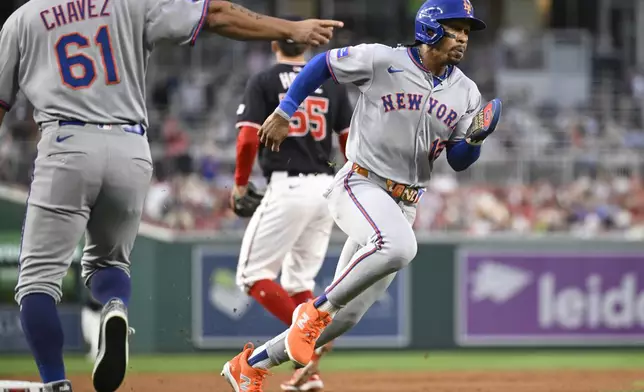 New York Mets' Francisco Lindor heads to home plate to score on a Mets' Brandon Nimmo RBI single during the third inning of a baseball game Tuesday, Aug. 19, 2025, in Washington. (AP Photo/John McDonnell)