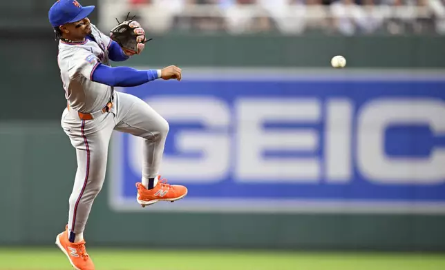 New York Mets shortstop Francisco Lindor throw out Washington Nationals Dylan Crews at first base during the second inning of a baseball game Tuesday, Aug. 19, 2025, in Washington. (AP Photo/John McDonnell)