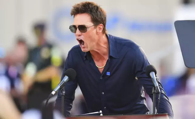 Former New England Patriots quarterback Tom Brady speaks after a bronze statue of himself was unveiled in Patriot Place Plaza before an NFL preseason football game between the Washington Commanders and the New England Patriots Friday, Aug. 8, 2025, in Foxborough, Mass. (AP Photo/Charles Krupa)
