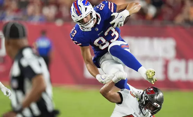 Buffalo Bills tight end Keleki Latu goes over Tampa Bay Buccaneers cornerback Roman Parodie during the second half of an NFL preseason football game, Saturday, Aug. 23, 2025, in Tampa, Fla. (AP Photo/Chris O'Meara)