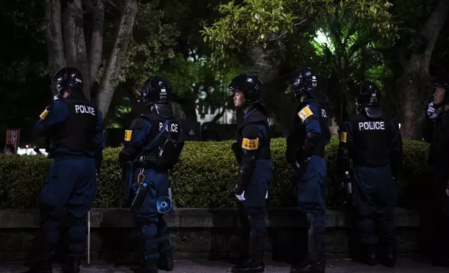 Police officers watch outside the Atomic Bomb Dome ahead of the memorial service to mark the 80th anniversary of the WWII U.S. atomic bombing in Hiroshima, Wednesday, Aug. 6, 2025, in Japan. (AP Photo/Louise Delmotte)