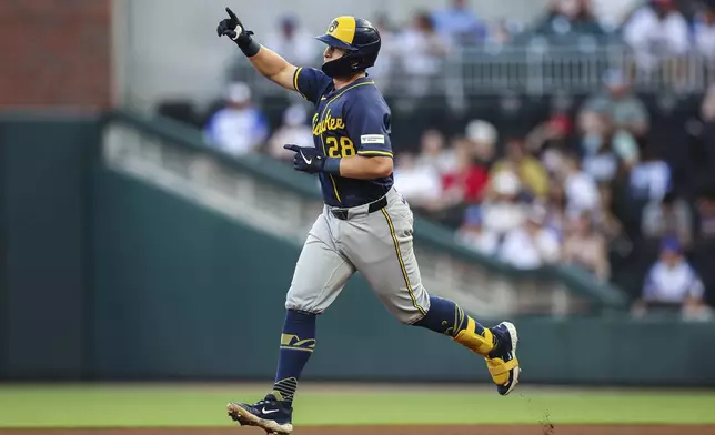 Milwaukee Brewers' Andrew Vaughn (28) hits a solo home run in the fourth inning of a baseball game against the Atlanta Braves, Wednesday, Aug. 6, 2025, in Atlanta. (AP Photo/Colin Hubbard)