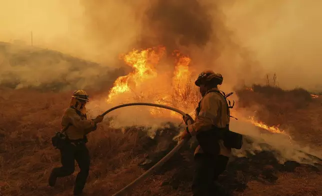 Firefighters battle the Canyon Fire on Thursday, Aug. 7, 2025, in Halsey Canyon, Calif. (AP Photo/Marcio Jose Sanchez)