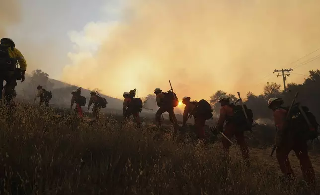 A California Department of Corrections fire crew battles the Canyon Fire on Thursday, Aug. 7, 2025, in Halsey Canyon, Calif. (AP Photo/Marcio Jose Sanchez)