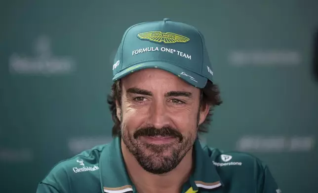 Aston Martin driver Fernando Alonso of Spain smiles ahead of the Formula One Hungarian Grand Prix at the Hungaroring racetrack in Mogyorod near Budapest, Hungary, Thursday, July 31, 2025. (Boglarka Bodnar/MTI via AP)