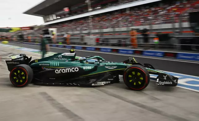 Aston Martin driver Fernando Alonso of Spain steers his car out of the garage during the second free practice at the Hungaroring racetrack in Mogyorod, Hungary, Friday, Aug. 1, 2025, ahead of the Hungarian Formula One Grand Prix. (AP Photo/Denes Erdos)
