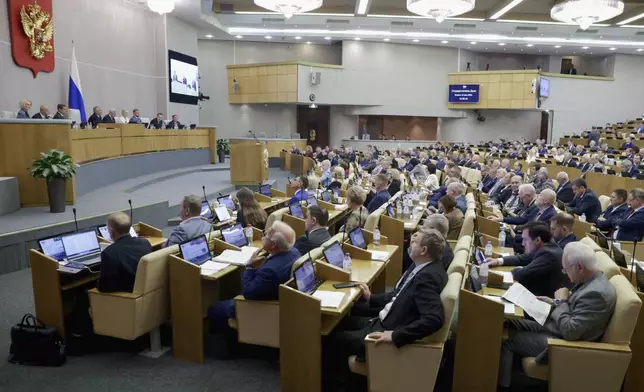 In this photo released by the State Duma, deputies attend a session at the State Duma, the lower house of the Russian parliament, in Moscow, Russia, Tuesday, July 22, 2025. (The State Duma, Lower House of the Russian Parliament Press Service via AP)