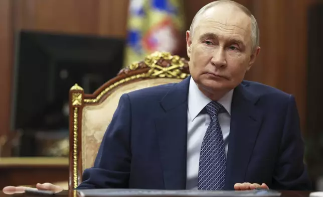 Russian President Vladimir Putin speaks with Sberbank CEO German Gref during their meeting at the Kremlin in Moscow, Russia, Tuesday, July 29, 2025. (Mikhail Metzel, Sputnik, Kremlin Pool Photo via AP)