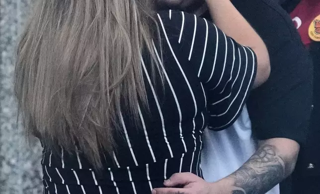 Jennifer Vasquez Sura, left, hugs her husband Kilmar Abrego Garcia at the Immigration and Customs Enforcement field office in Baltimore, Monday, Aug. 25, 2025. (AP Photo/Stephanie Scarbrough)