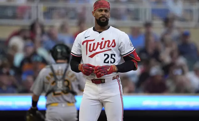 Minnesota Twins' Byron Buxton (25) stands at the plate after striking out to end the bottom of the third inning of a baseball game against the Athletics Tuesday, Aug. 19, 2025, in Minneapolis. (AP Photo/Abbie Parr)