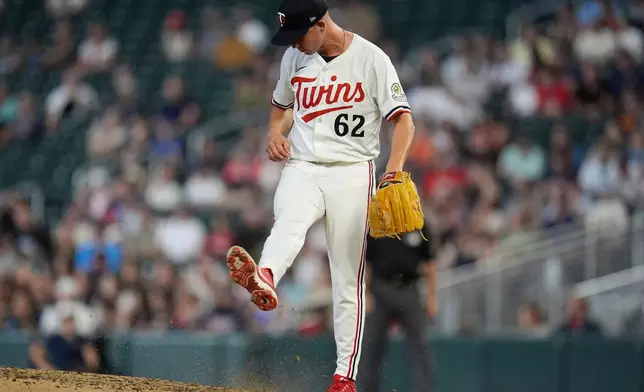Minnesota Twins relief pitcher Pierson Ohl (62) kicks dirt after an RBI-single by Athletics' Brett Harris (11) during the sixth inning of a baseball game Tuesday, Aug. 19, 2025, in Minneapolis. (AP Photo/Abbie Parr)