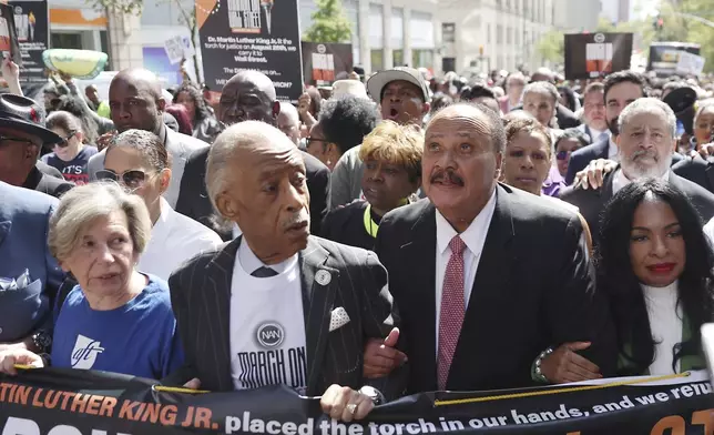 Martin Luther King III, right, walks next to Rev. Al Sharpton for the March on Wall Street, Thursday, Aug. 28, 2025, in New York. (AP Photo/Heather Khalifa)