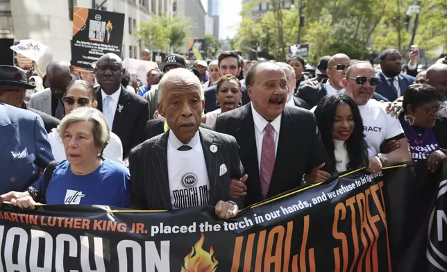Rev. Al Sharpton, center, alongside Martin Luther King III, walk for the March on Wall Street, Thursday, Aug. 28, 2025, in New York. (AP Photo/Heather Khalifa)