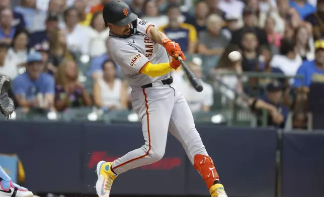 San Francisco Giants' Willy Adames hits a home run during the first inning of a baseball game against the Milwaukee Brewers, Friday, Aug. 22, 2025, in Milwaukee. (AP Photo/Jeffrey Phelps)