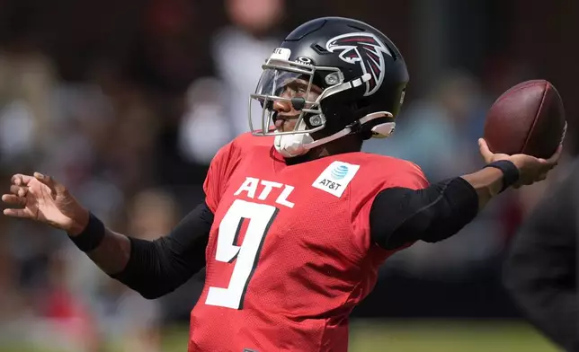 Atlanta Falcons quarterback Michael Penix Jr. works out during a joint NFL football practice between the Atlanta Falcons and the Tennessee Titans, Wednesday, Aug. 13, 2025, in Flowery Branch, Ga. (AP Photo/Mike Stewart)