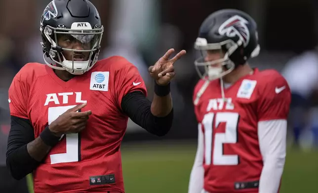 Atlanta Falcons quarterback Michael Penix Jr. (9) and Easton Stick (12) work out during a joint NFL football practice between the Atlanta Falcons and the Tennessee Titans, Wednesday, Aug. 13, 2025, in Flowery Branch, Ga. (AP Photo/Mike Stewart)