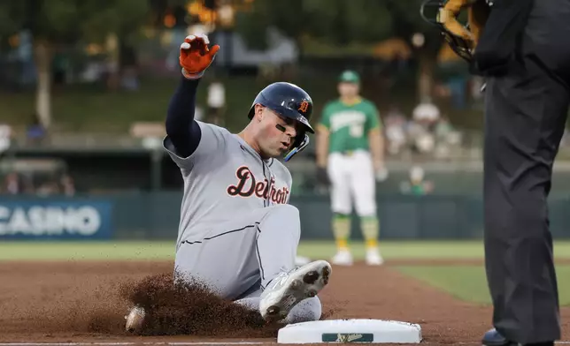 Detroit Tigers' Spencer Torkelson slides into third base after hitting a triple during the second inning of a baseball game against the Athletic,s Wednesday, Aug. 27, 2025, in West Sacramento, Calif. (AP Photo/Sergio Estrada)