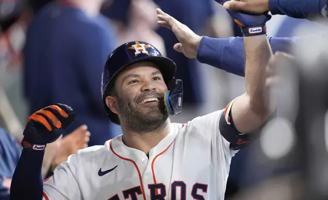 Houston Astros' Jose Altuve celebrates in the dugout after hitting a home run against the Colorado Rockies during the first inning of a baseball game Thursday, Aug. 28, 2025, in Houston. (AP Photo/David J. Phillip)
