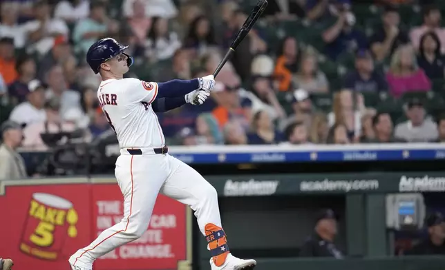 Houston Astros' Christian Walker hits a home run against the Colorado Rockies during the eighth inning of a baseball game Thursday, Aug. 28, 2025, in Houston. (AP Photo/David J. Phillip)