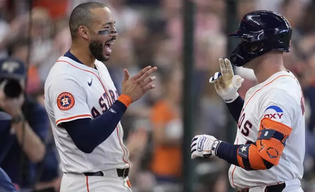 Houston Astros' Christian Walker, right, celebrates with Carlos Correa after hitting a home run against the Colorado Rockies during the eighth inning of a baseball game Thursday, Aug. 28, 2025, in Houston. (AP Photo/David J. Phillip)