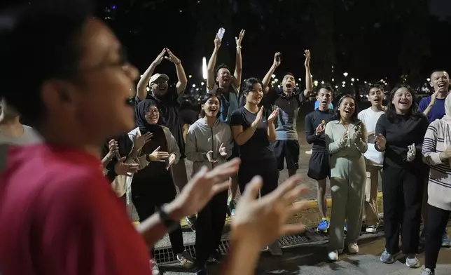 Participants cheer during a community playing gathering in Jakarta, Indonesia, Friday, July 11, 2025. (AP Photo/Dita Alangkara)