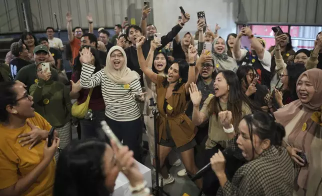 Participants sing and dance during a gathering of "Nyanyi Bareng Jakarta" or "Singing Together Jakarta" in Jakarta, Indonesia, Saturday, July 19, 2025. (AP Photo/Dita Alangkara)