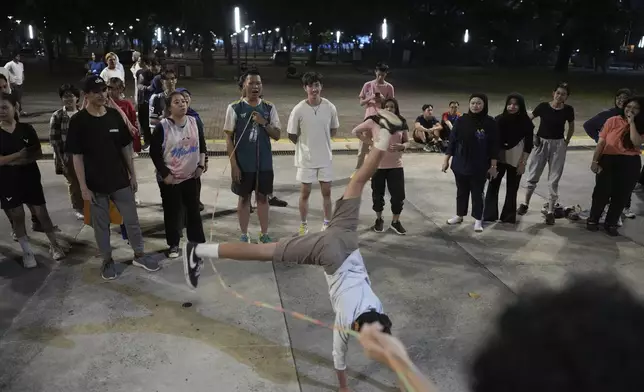 People play jump rope during a community playing gathering in Jakarta, Indonesia, Friday, July 11, 2025. (AP Photo/Dita Alangkara)