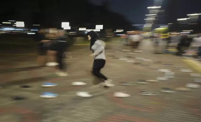 A woman participates in a community playing gathering in Jakarta, Indonesia, Friday, July 11, 2025. (AP Photo/Dita Alangkara)