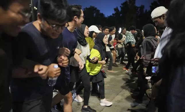 People participate in a community playing gathering in Jakarta, Indonesia, Friday, July 11, 2025. (AP Photo/Dita Alangkara)