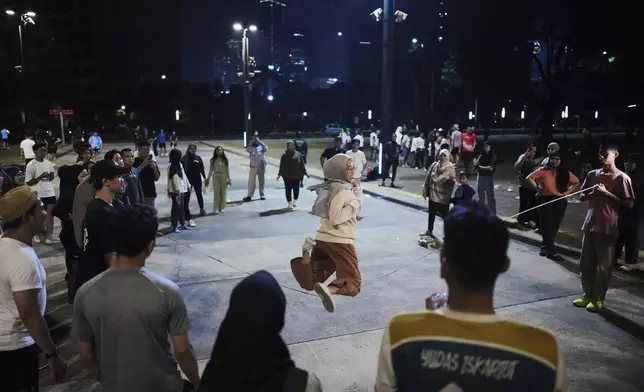 A participant plays jump rope during a community playing gathering in Jakarta, Indonesia, Friday, July 11, 2025. (AP Photo/Dita Alangkara)